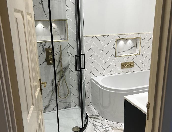 Bathroom with white tiles and gold features